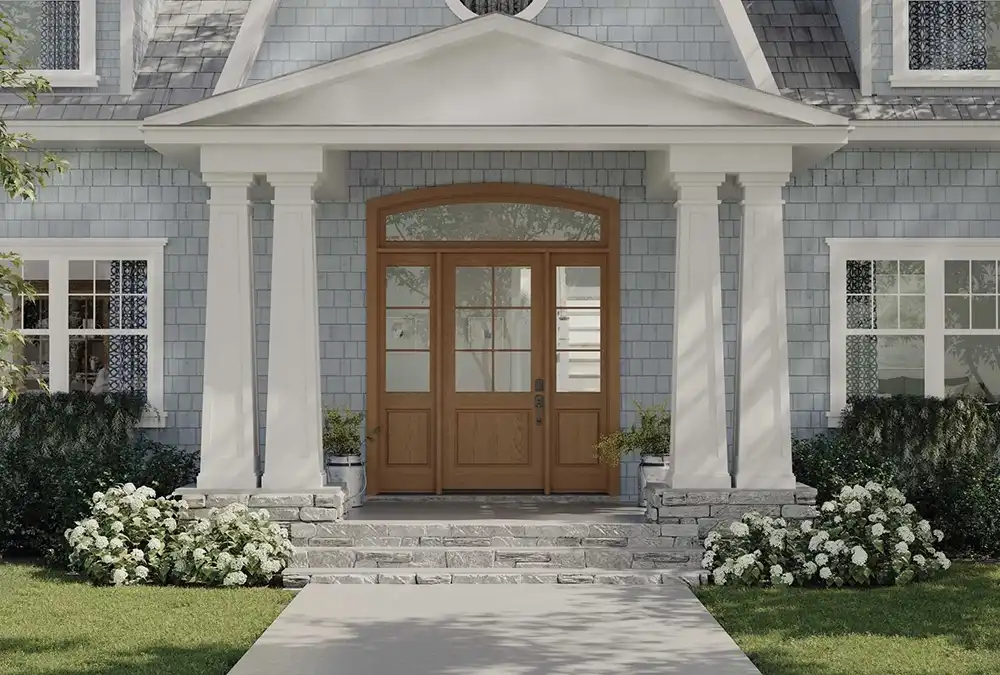 Street view of a TruStile Cape Cod Front Door in Hazelnut color with a four-column entry way.