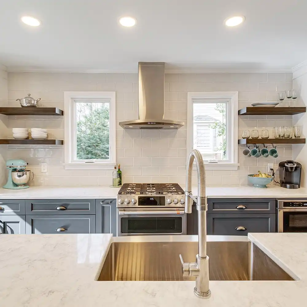 Interior view of a kitchen with white casement windows.