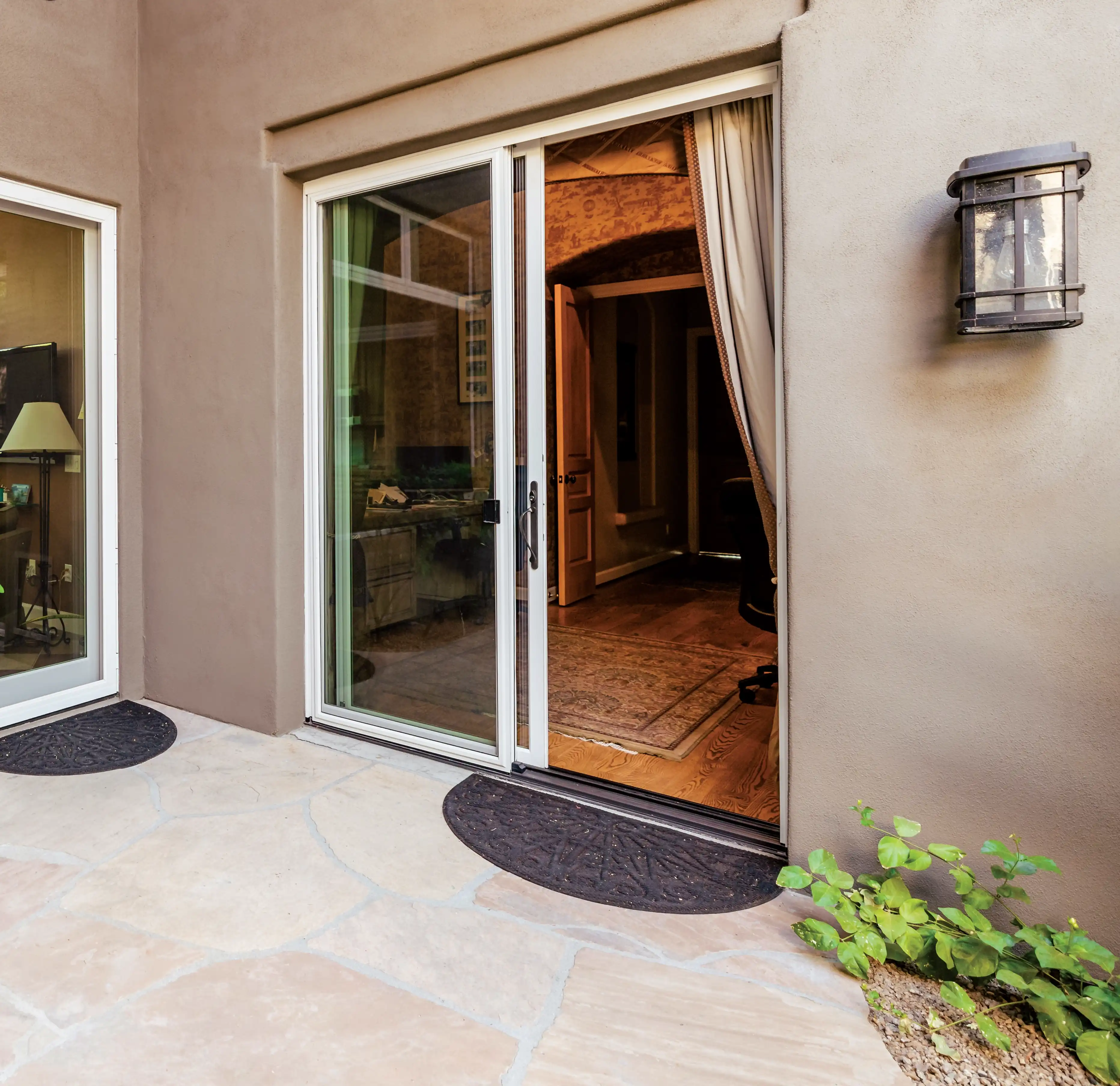 Exterior view of a white Marvin Replacement white sliding glass patio door.