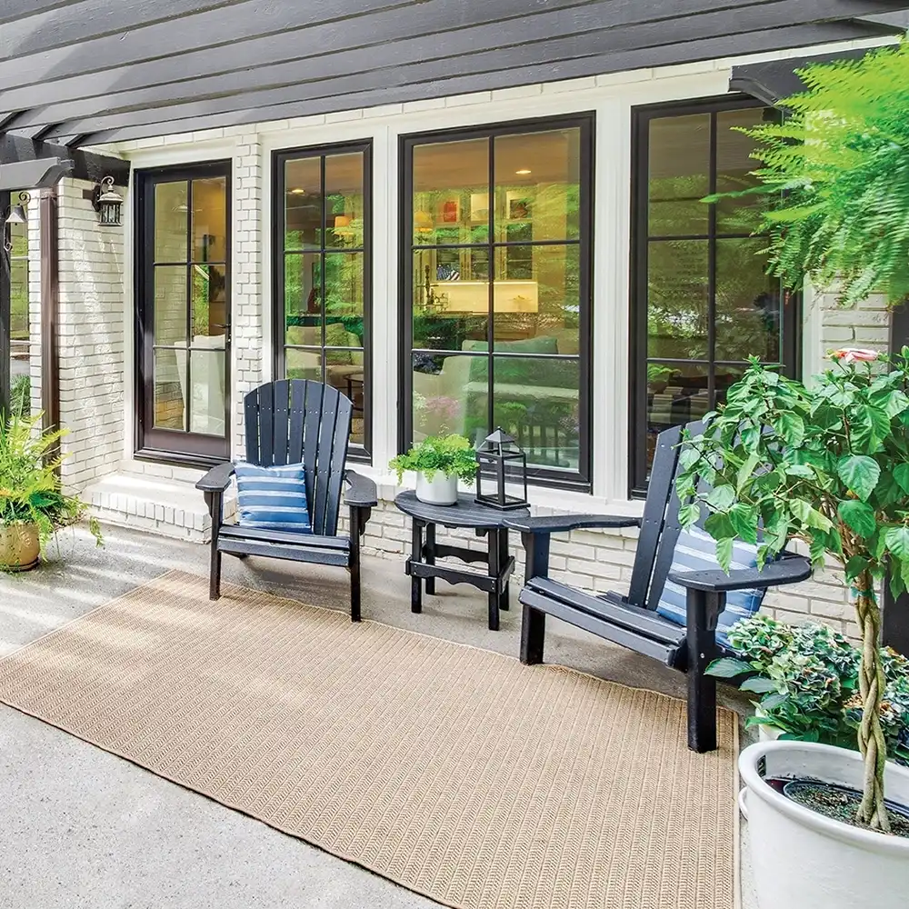 Porch exterior with black Marvin Replacement Casement picture windows.