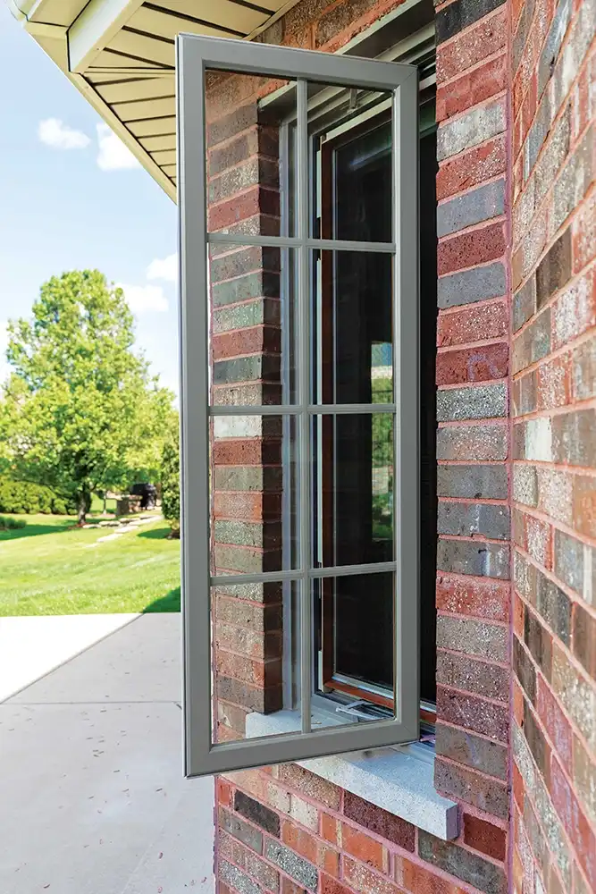 Outside view of an opened Marvin Replacement casement window with divided lites