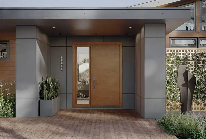 View of a TruStile Modern Front Door in Nutmeg color with a sidelite on the left on a gray house.