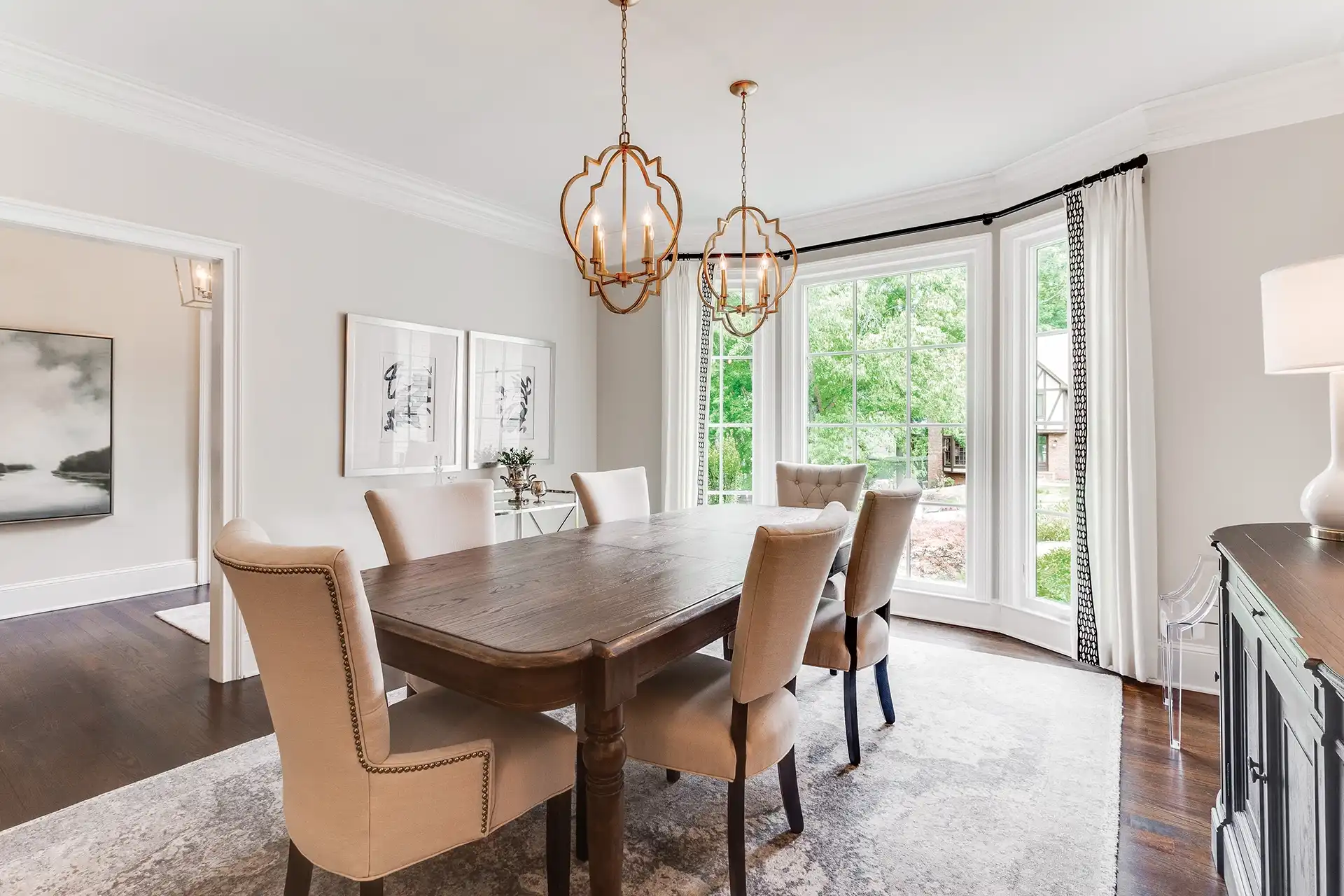 Interior dining room with a white three-pane Marvin Replacement picture window