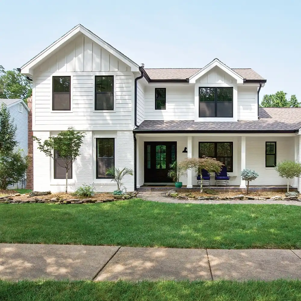 Exterior view of a white home with black Marvin Replacement windows in Charlotte