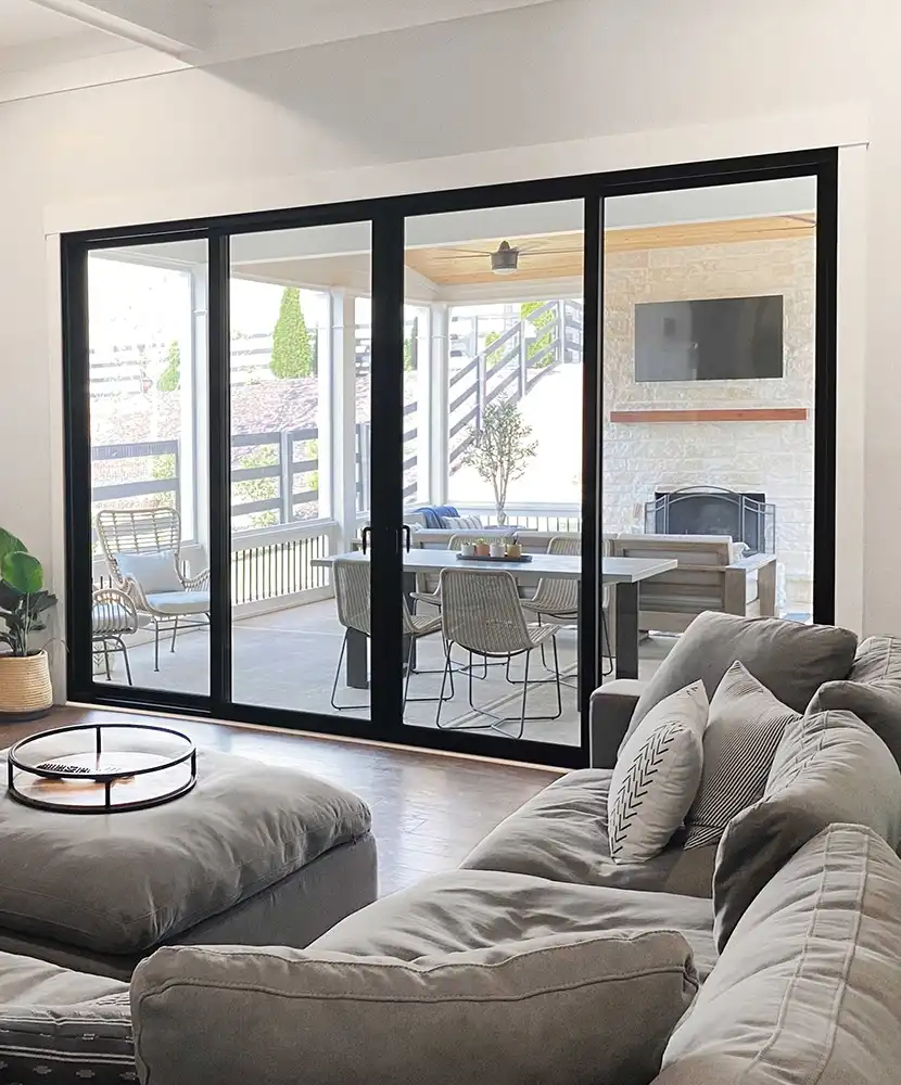 Interior living room image featuring a Sliding Patio Door in Ebony finish that leads to a patio.