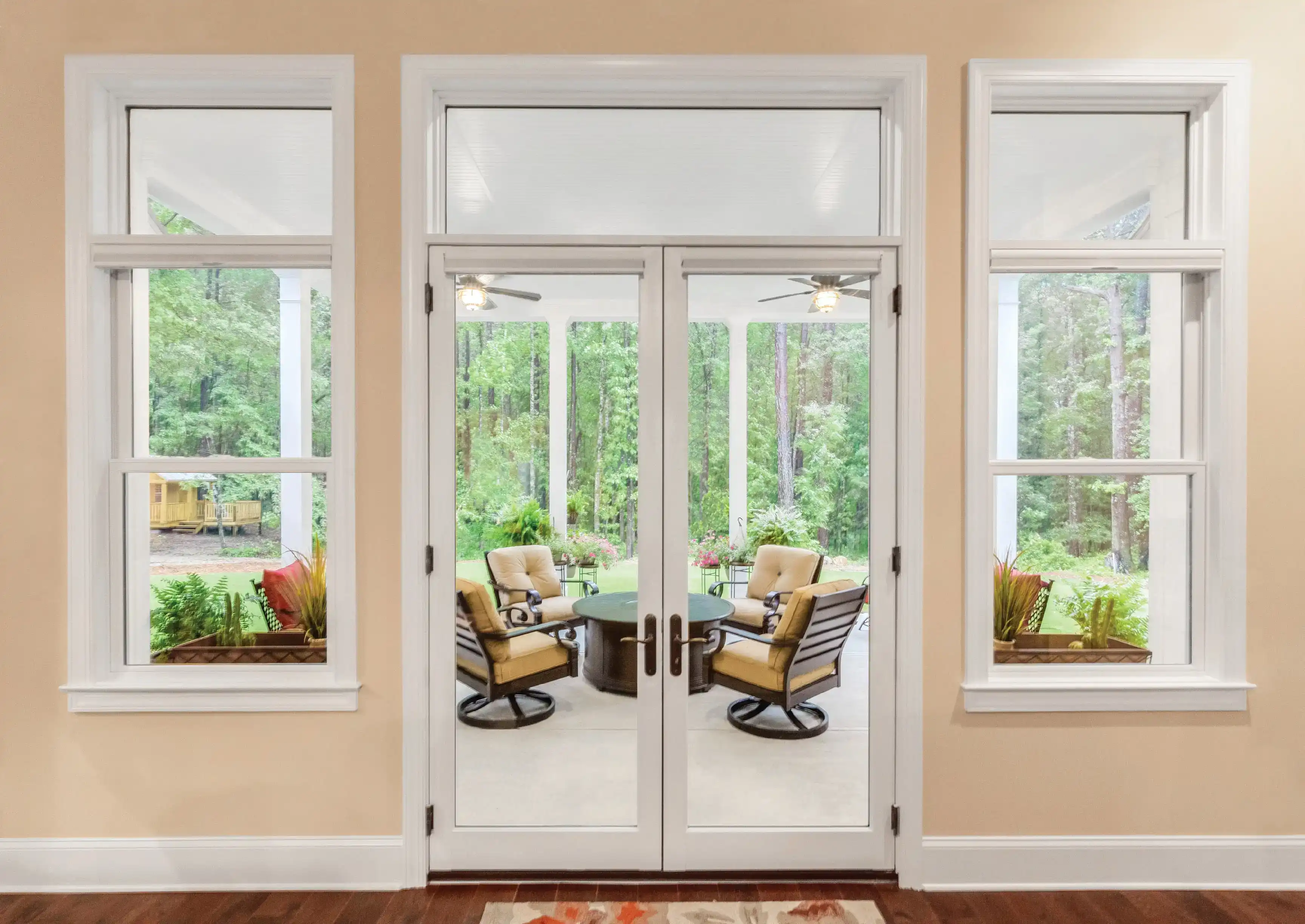 inswing patio door framed by double hung windows