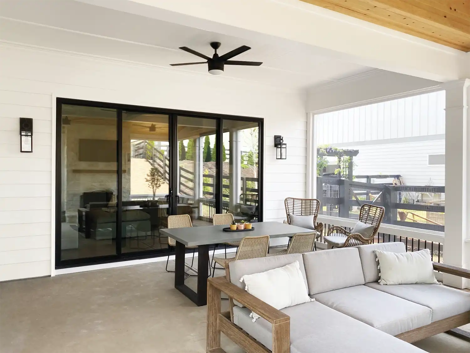 Exterior porch image featuring a Sliding Patio Door in Ebony finish with Matte Black Northfield hardware and a Bronze sill.