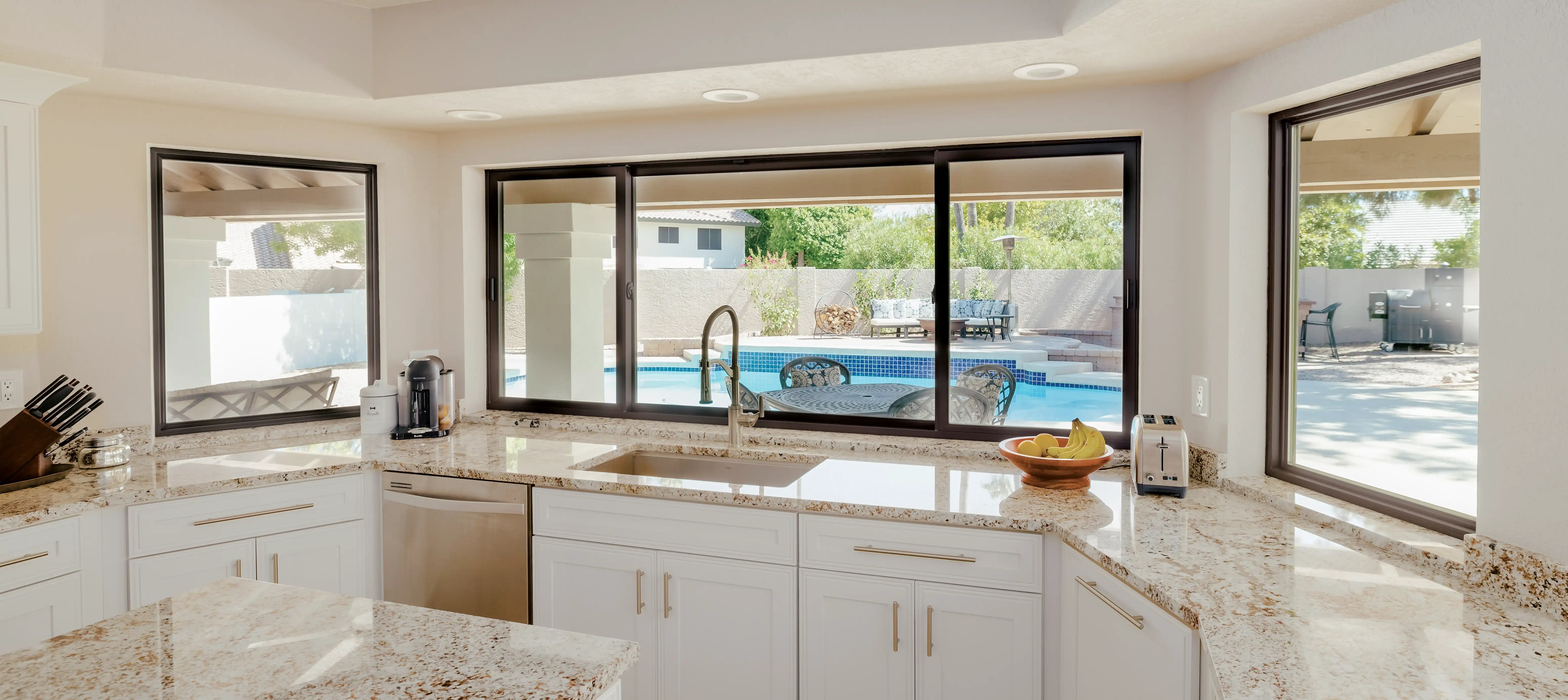 Interior view of Marvin Replacement Slider picture window overlooking an outdoor pool.