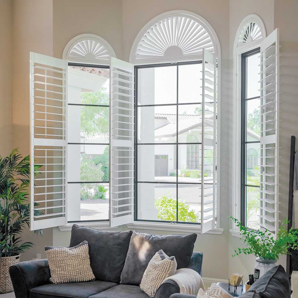 Interior view of living room picture windows with black window grilles.