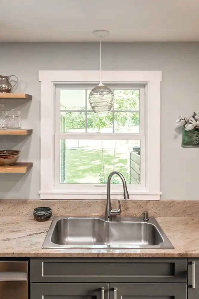 Interior view of a white Marvin Replacement double hung window above a kitchen sink.