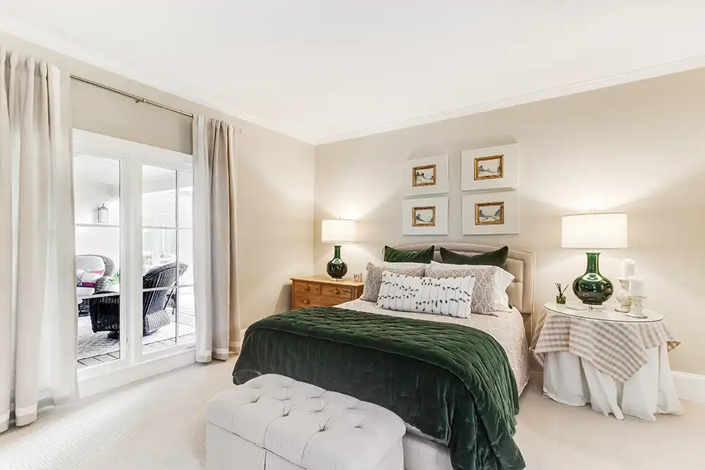 Interior view of a white bedroom with side-by-side casement windows.