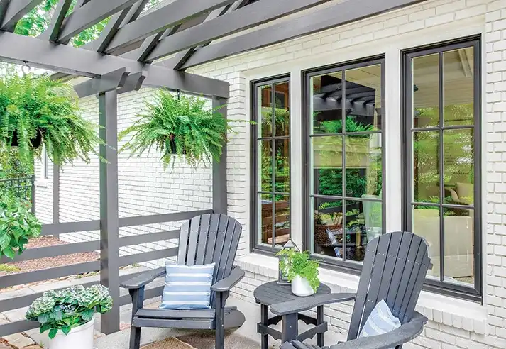 Home exterior view from a patio featuring Marvin Replacement Casement windows.