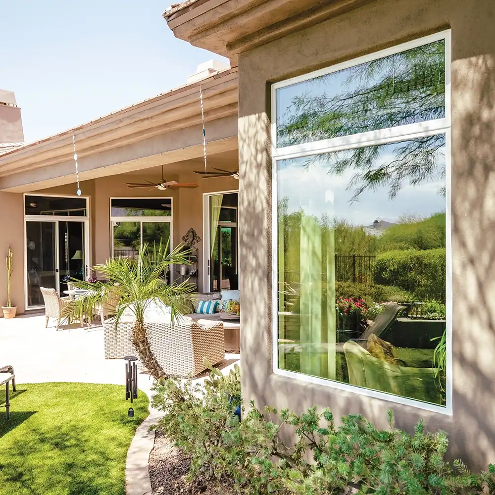 Exterior view of white Marvin Replacement windows on a stucco home