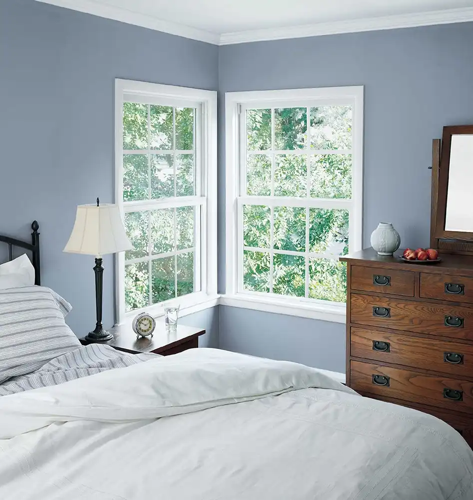 double windows hung in blue bedroom