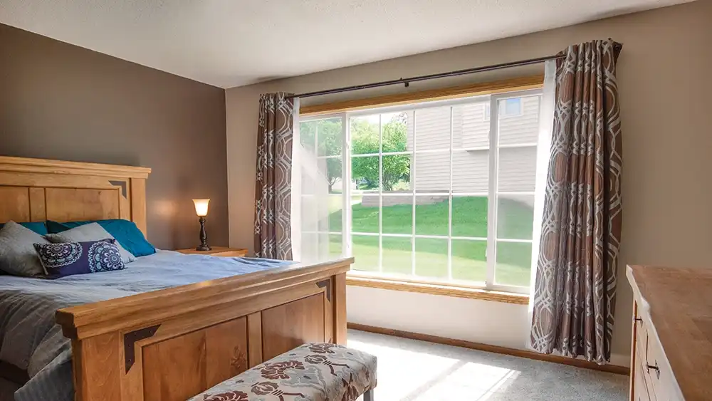 Interior view of a white slider window with three sash.