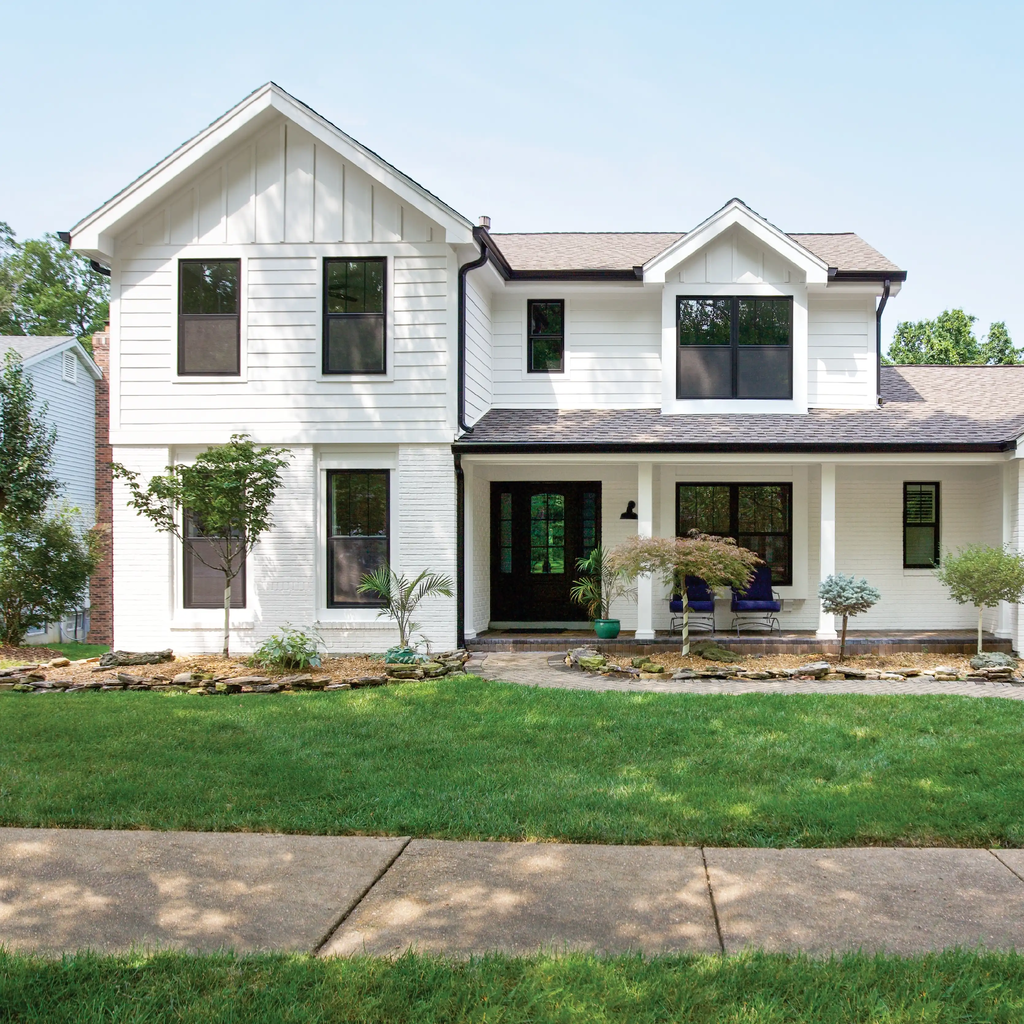 Exterior view of a white home with black Marvin Replacement windows in Charlotte.