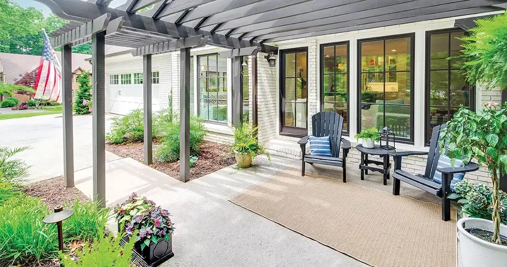 Outside view of a porch with black Marvin Replacement casement windows