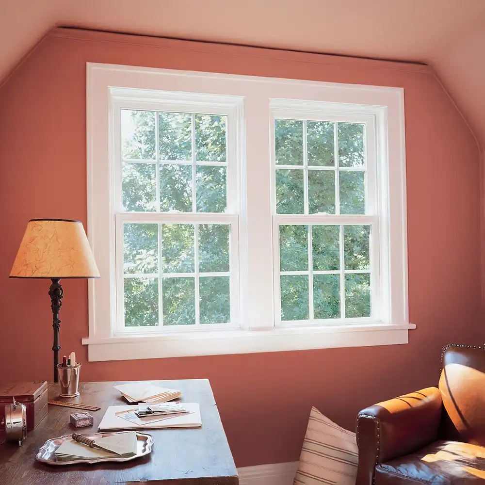 Interior view of two white single hung windows in a den.