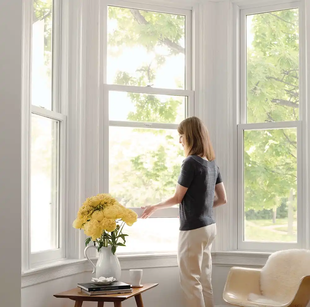 woman opening window