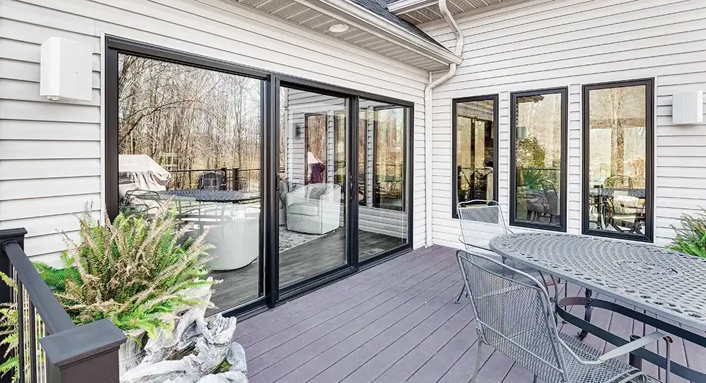 Exterior view of a three-panel black Marvin Replacement sliding glass door