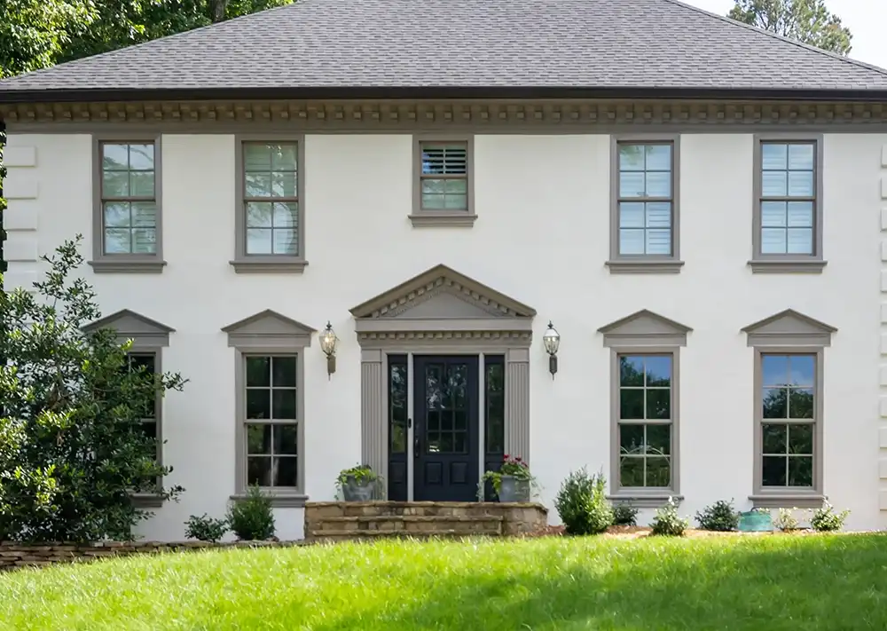 Exterior of stucco home with Marvin Replacement Double Hung windows.