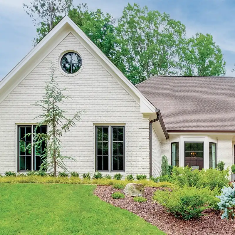 Exterior view of a white brick home in Seattle featuring Marvin Replacement windows.