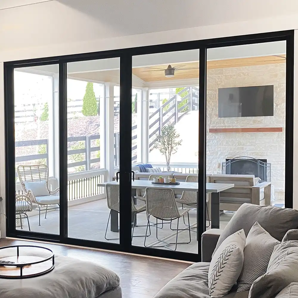 Interior view of a black four-panel Marvin Replacement Sliding French door.